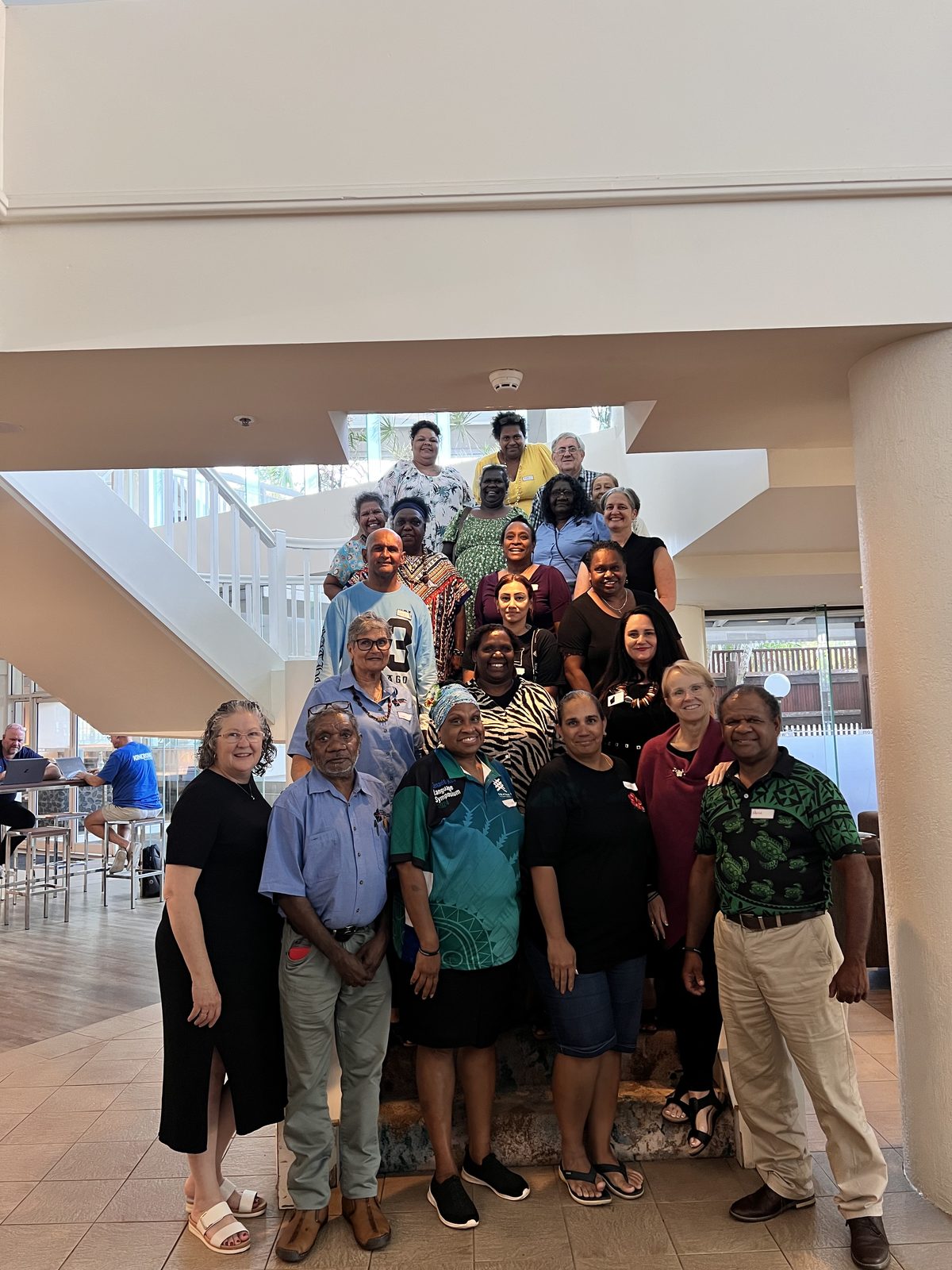 Jody with a large group of community members on a staircase